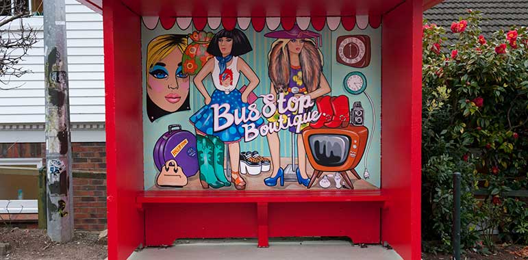 Bus shelter: 'Bus stop boutique' with 2 glamorous women.